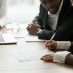 Greenville businesswoman signing business contract or document