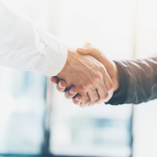 Business partnership meeting. Picture businessmans handshake. Successful businessmen handshaking after good deal. Horizontal, blurred background